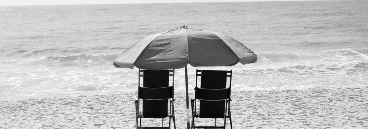 beach umbrella and two chairs on the beach